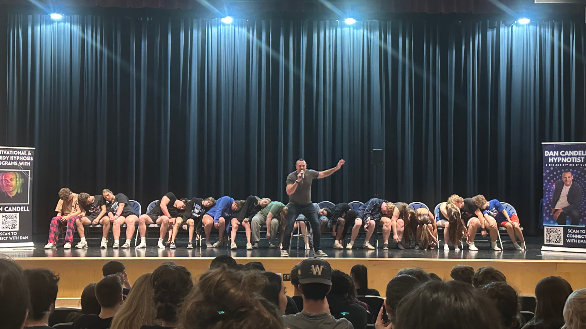 Dan Candell performing his Going Mental comedy stage hypnosis show for a packed auditorium